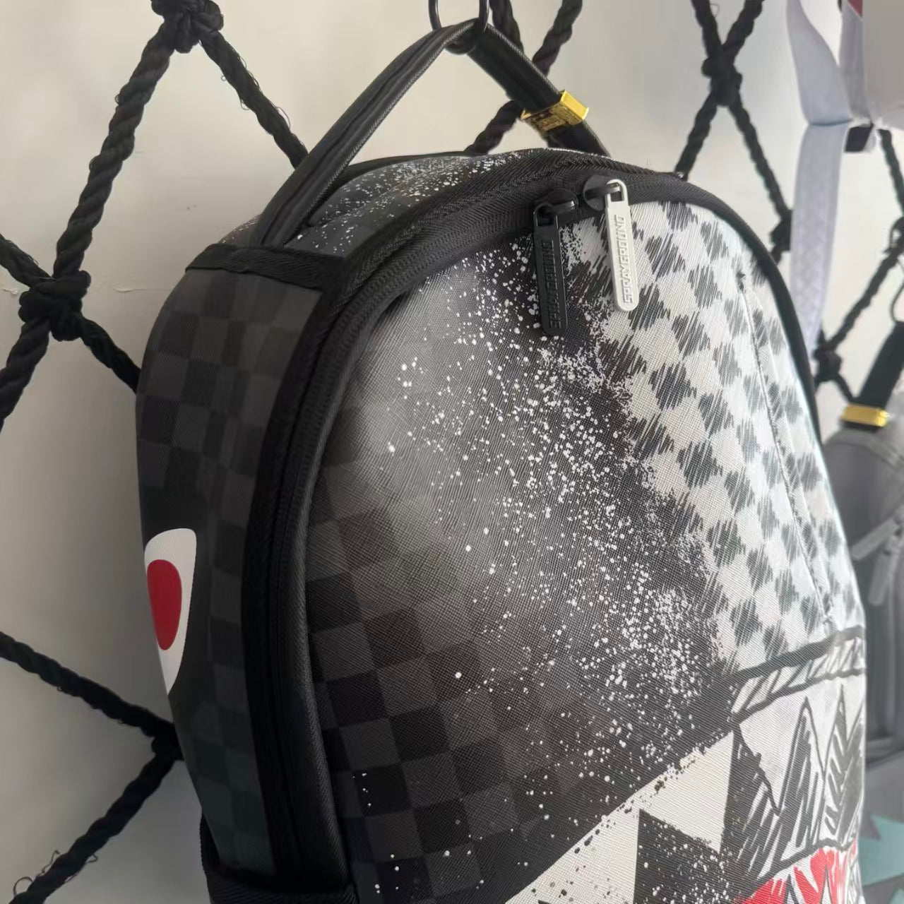 Urban Streetwear Backpack – Black & White Scribble Checkerboard with Shark Mouth and Splatter Design