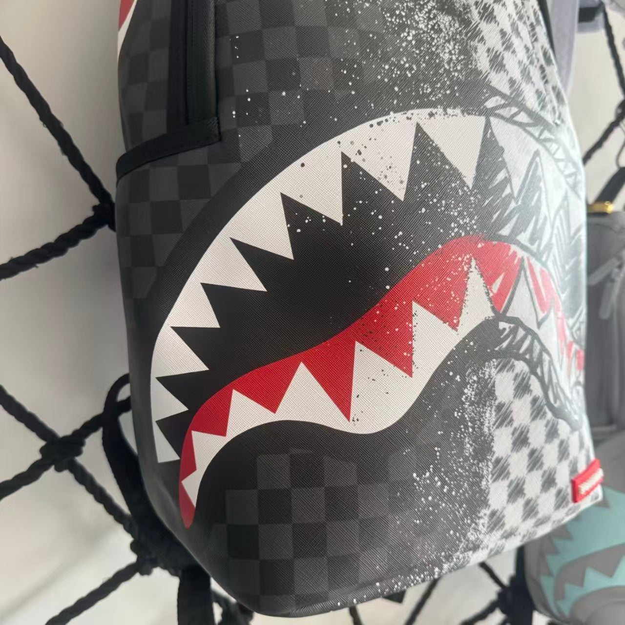 Urban Streetwear Backpack – Black & White Scribble Checkerboard with Shark Mouth and Splatter Design