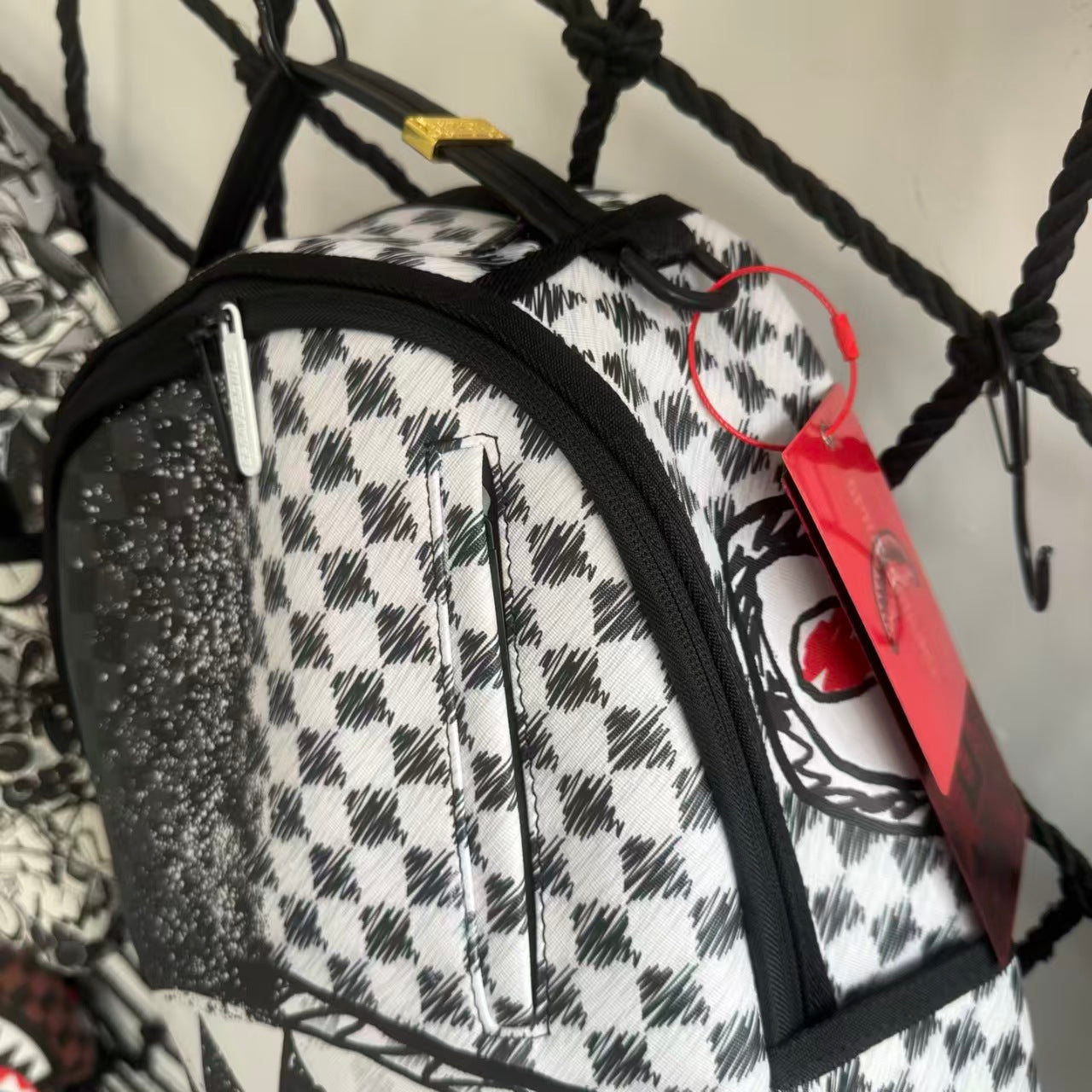 Urban Streetwear Backpack – Black & White Scribble Checkerboard with Shark Mouth and Splatter Design
