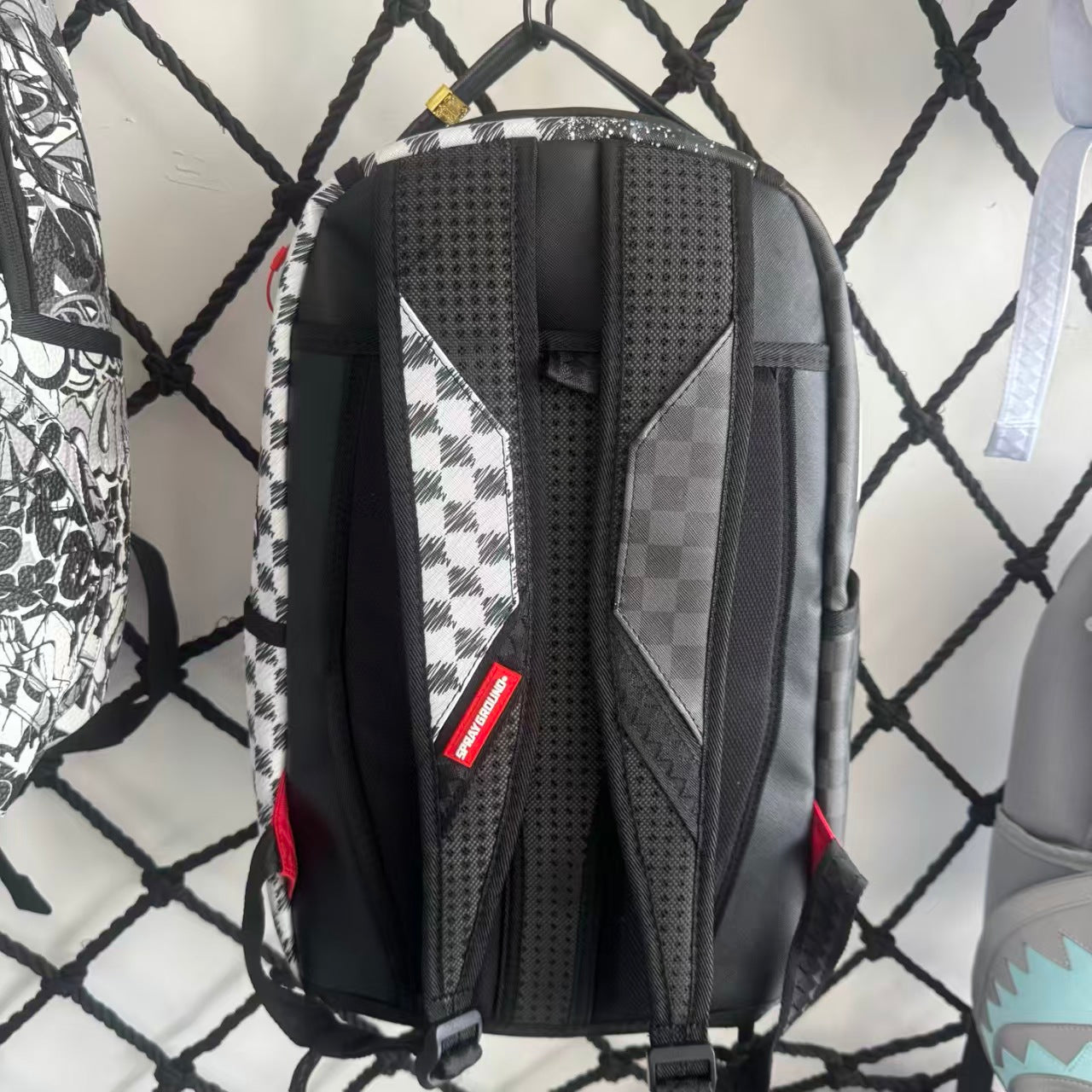 Urban Streetwear Backpack – Black & White Scribble Checkerboard with Shark Mouth and Splatter Design