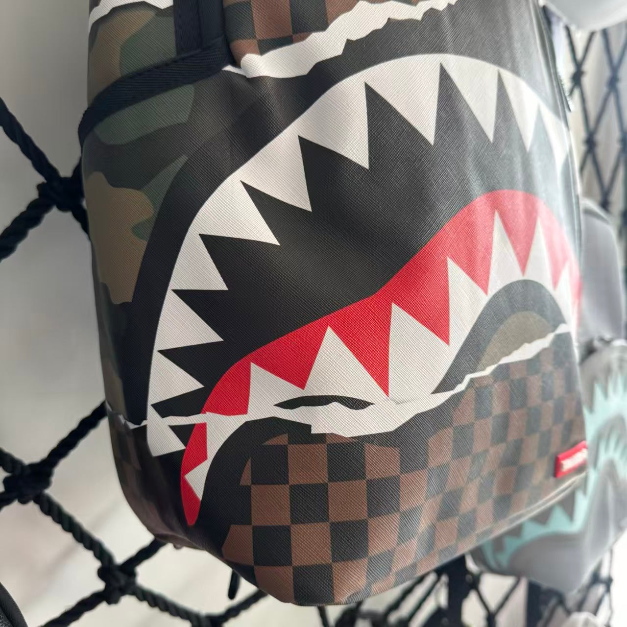 Urban Streetwear Backpack – Brown & Black Checkerboard Camo Torn-Paper Shark Mouth Design