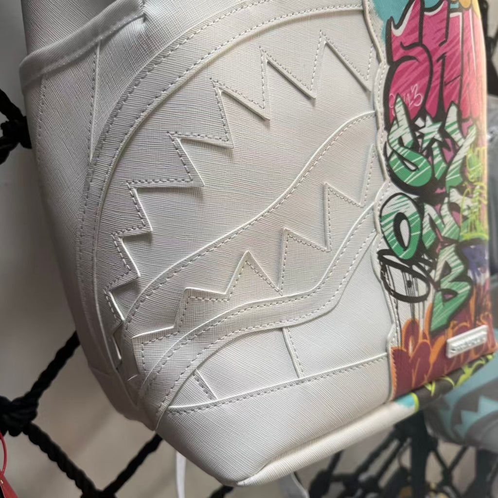 White Backpack with 3D Stitched Shark Mouth and Colorful Graffiti Splice Design