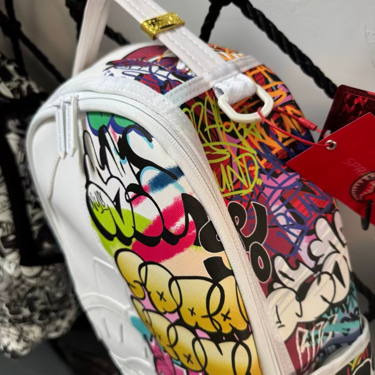 White Backpack with 3D Stitched Shark Mouth and Colorful Graffiti Splice Design