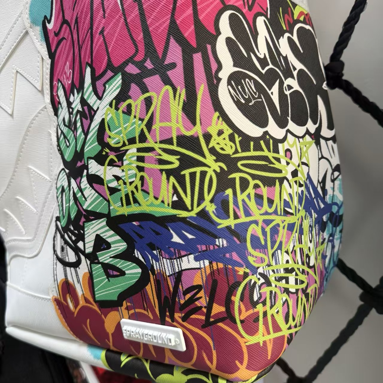 White Backpack with 3D Stitched Shark Mouth and Colorful Graffiti Splice Design