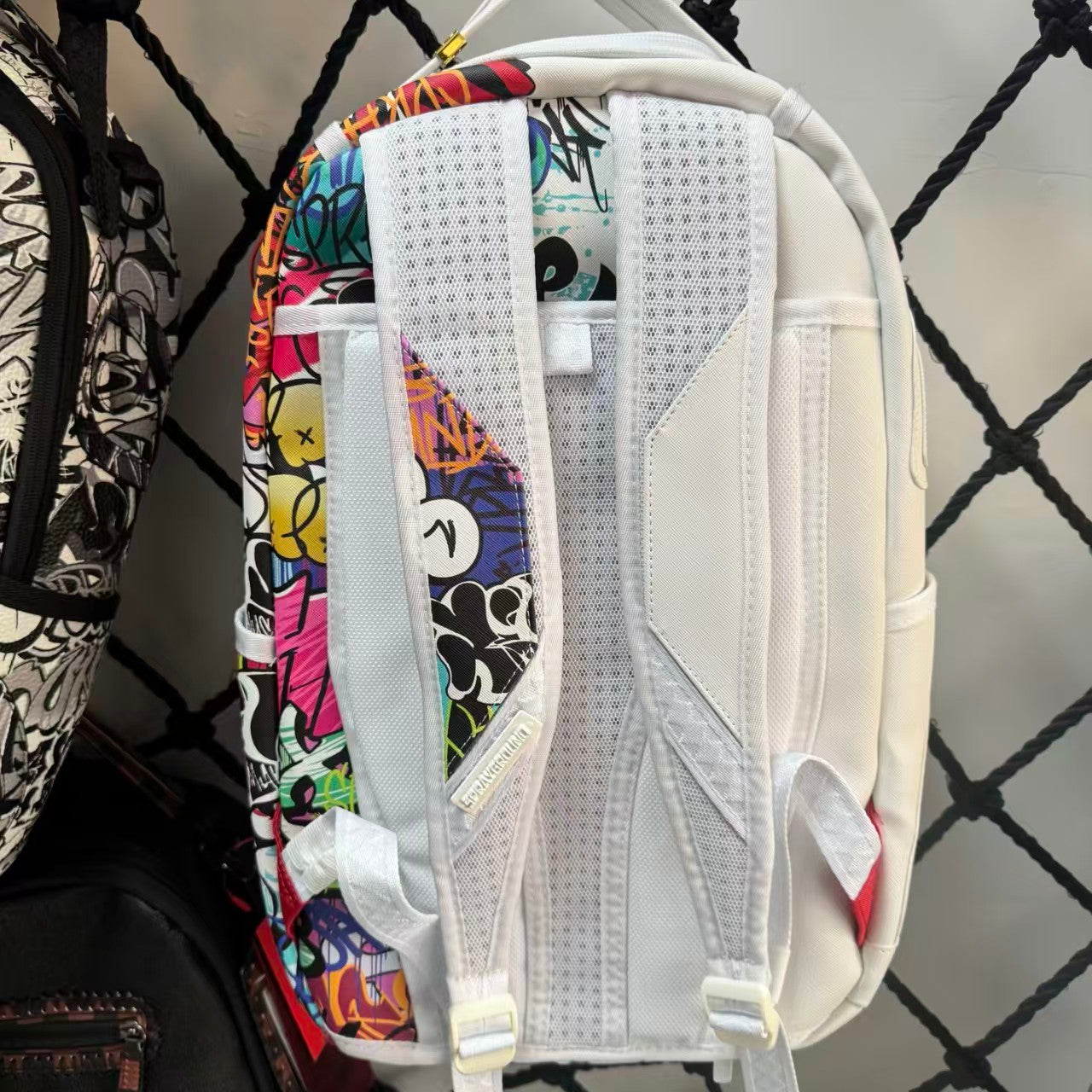 White Backpack with 3D Stitched Shark Mouth and Colorful Graffiti Splice Design