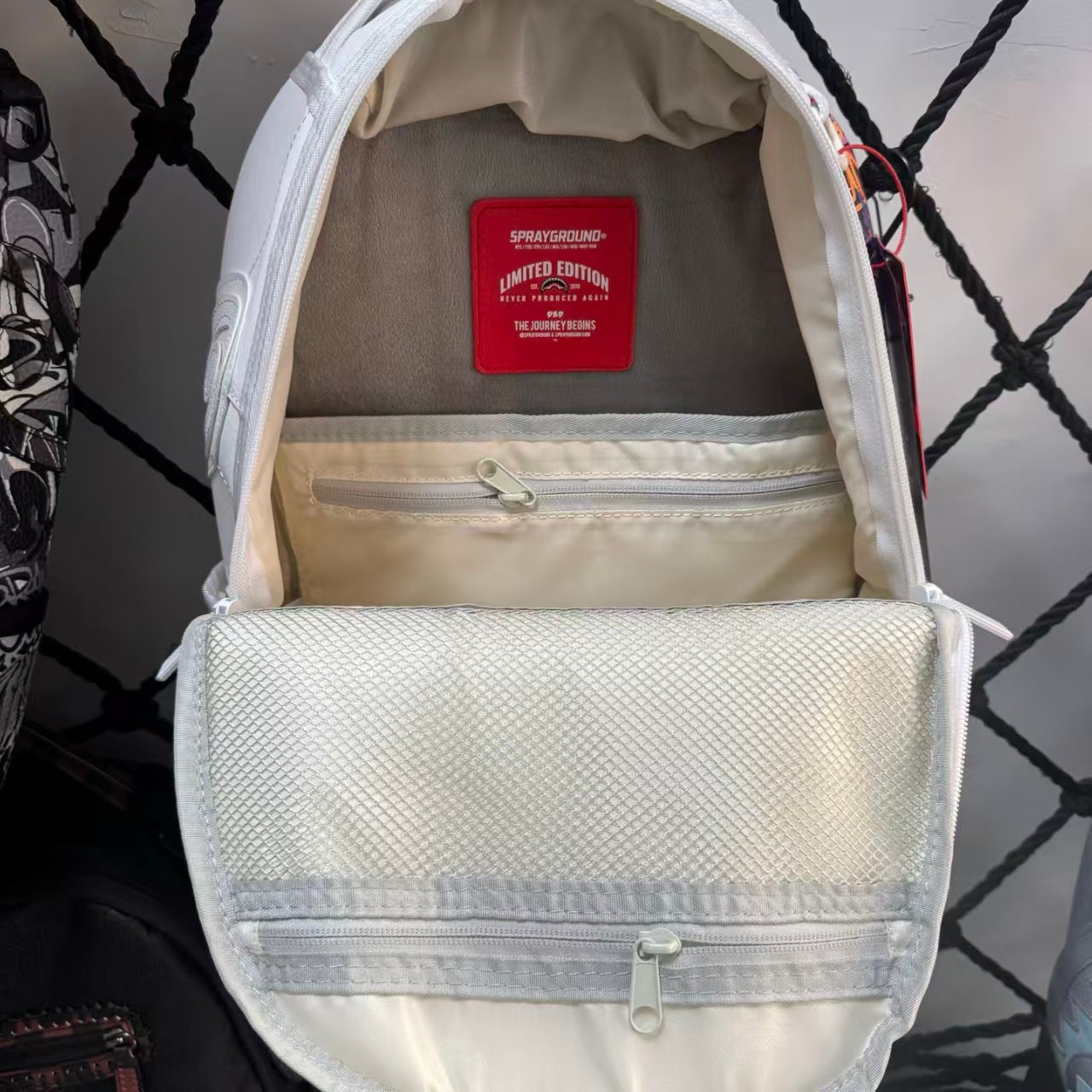 White Backpack with 3D Stitched Shark Mouth and Colorful Graffiti Splice Design