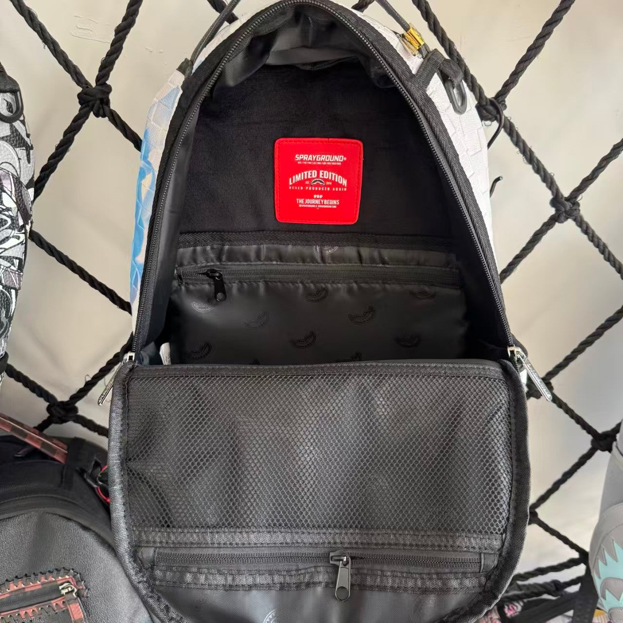 White 3D Woven Texture Streetwear Backpack - Grey-Blue Splatter Effect with Classic Shark Mouth Design