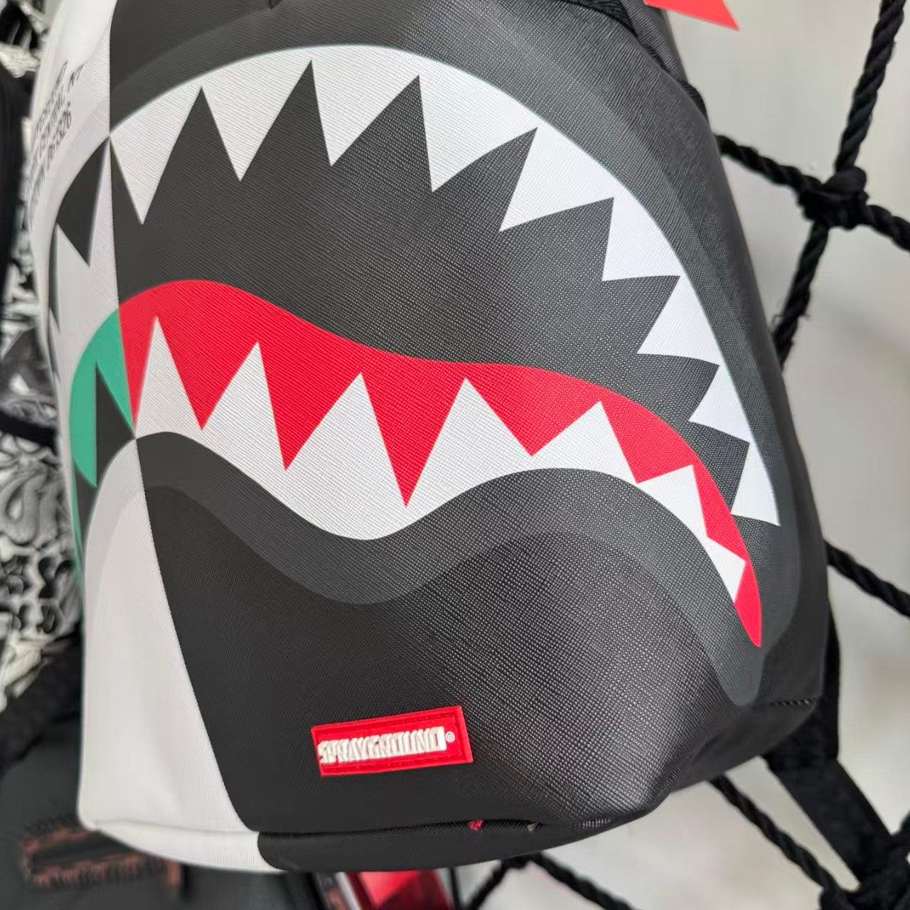 Black and White Split-Design Streetwear Backpack - Red and Green Contrast Shark Mouth with Text Print