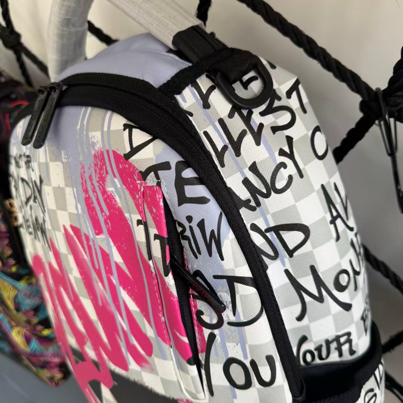 Pink Graffiti Splatter Streetwear Backpack - Grey Checkerboard with Handwritten Slogans and Shark Mouth Design