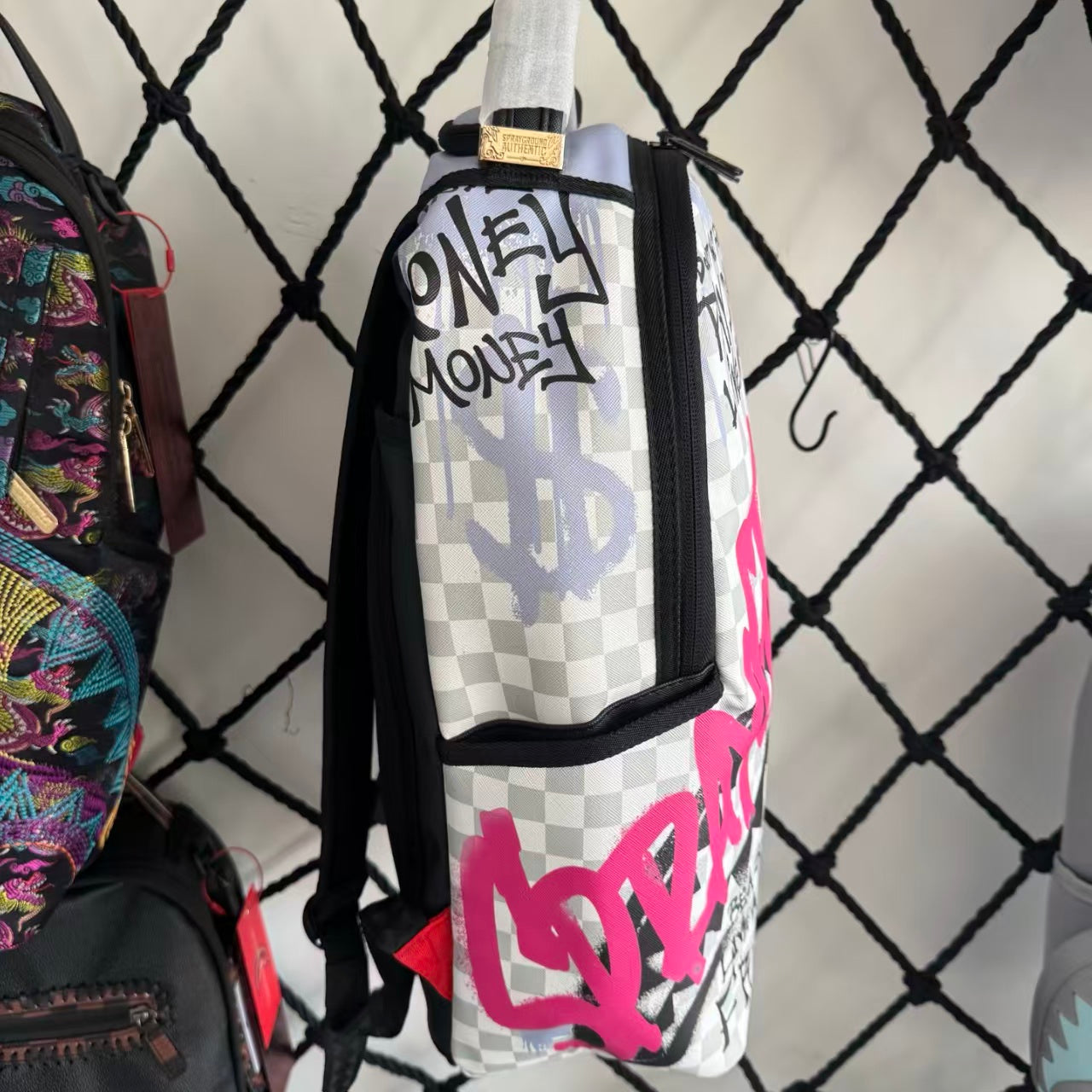 Pink Graffiti Splatter Streetwear Backpack - Grey Checkerboard with Handwritten Slogans and Shark Mouth Design