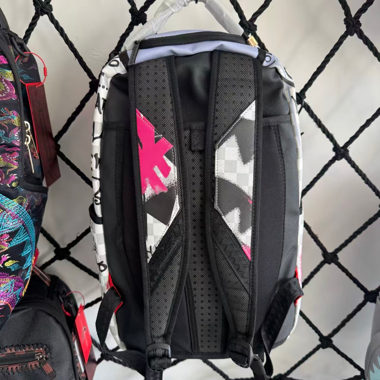 Pink Graffiti Splatter Streetwear Backpack - Grey Checkerboard with Handwritten Slogans and Shark Mouth Design