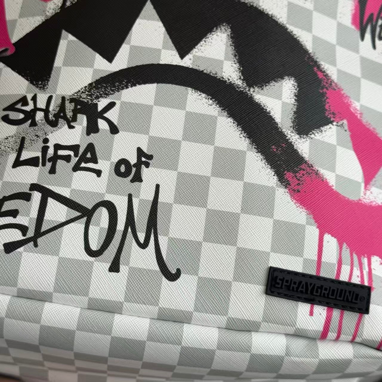 Pink Graffiti Splatter Streetwear Backpack - Grey Checkerboard with Handwritten Slogans and Shark Mouth Design