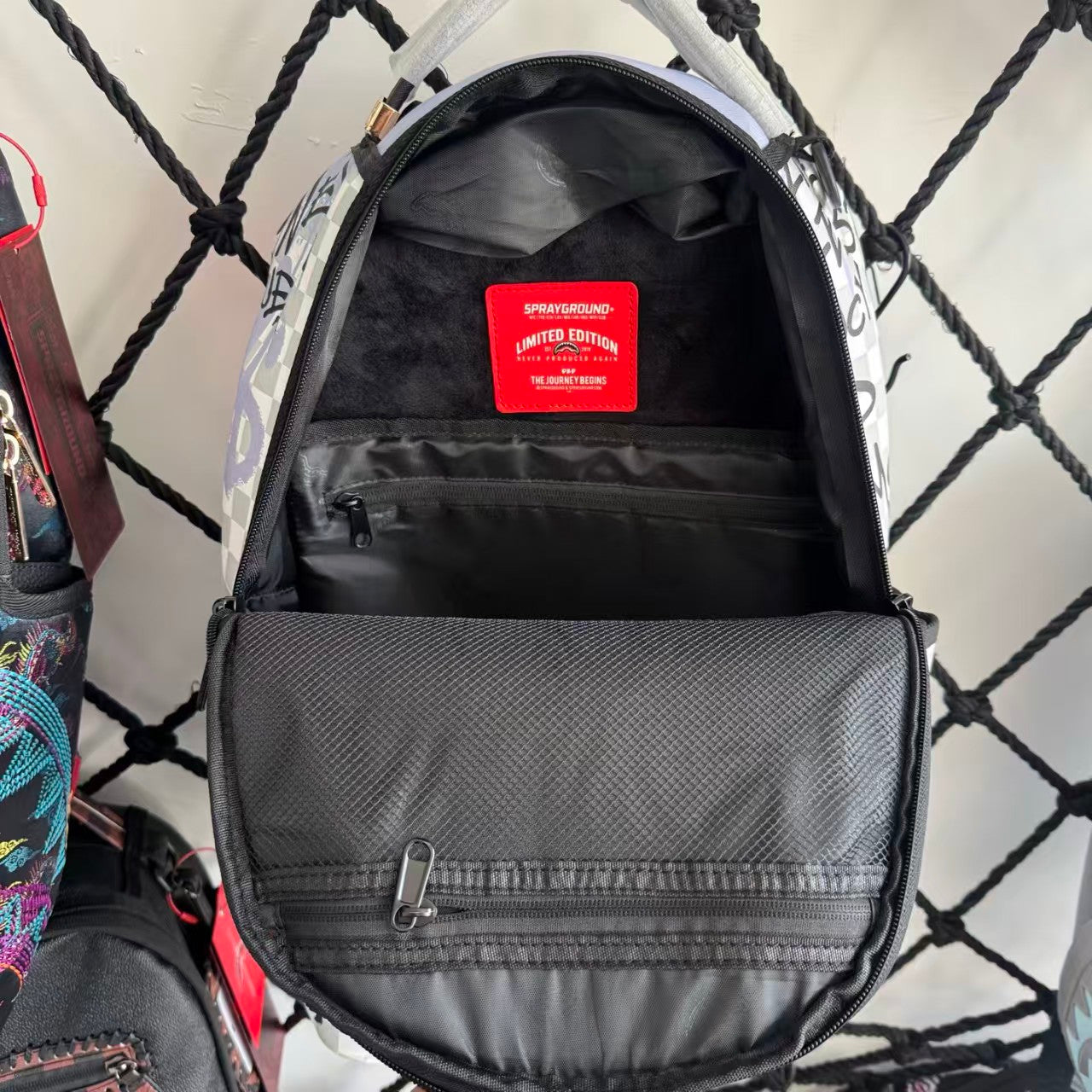 Pink Graffiti Splatter Streetwear Backpack - Grey Checkerboard with Handwritten Slogans and Shark Mouth Design