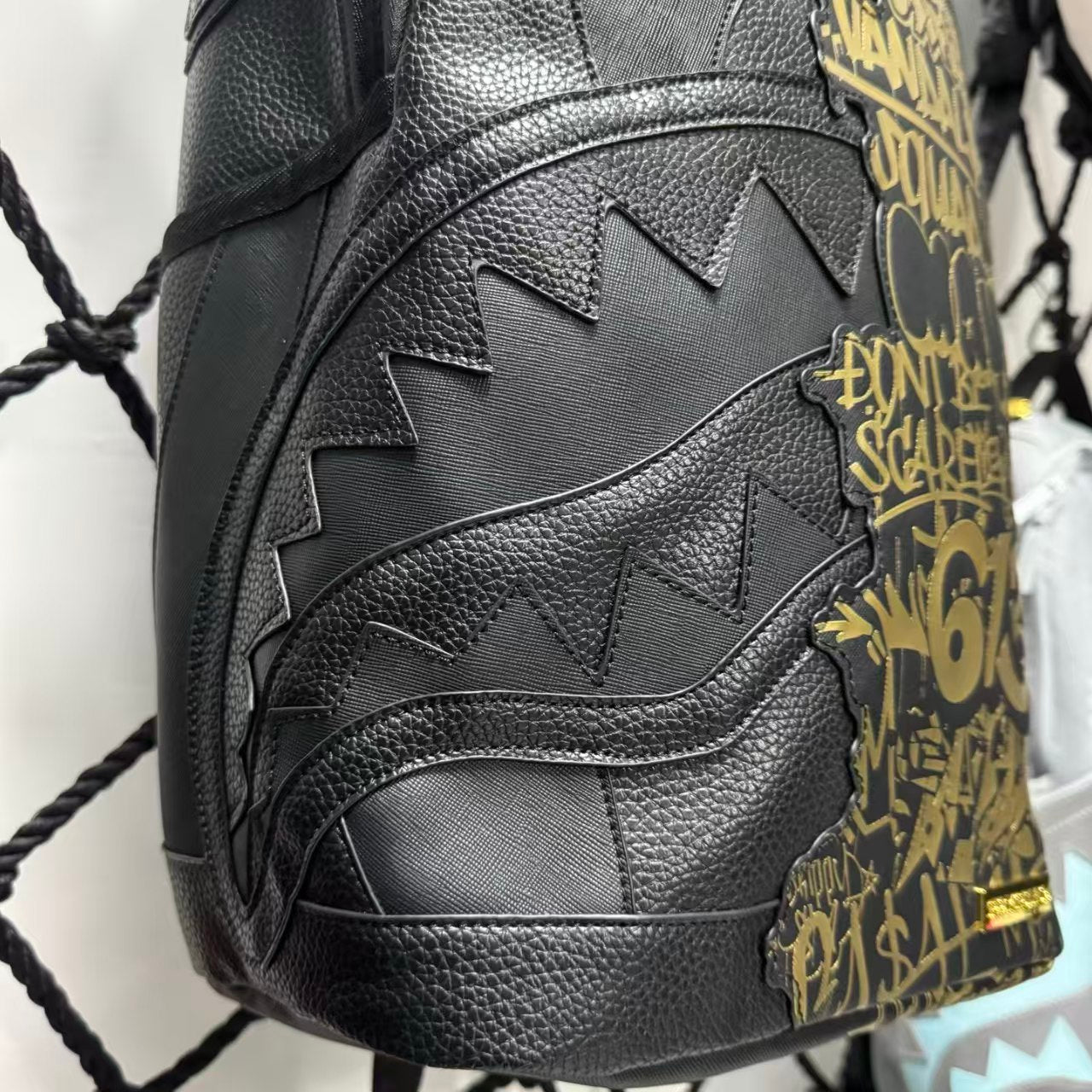 Black Textured Leather Streetwear Backpack - Gold Graffiti Lettering & 3D Shark Mouth Silhouette Design