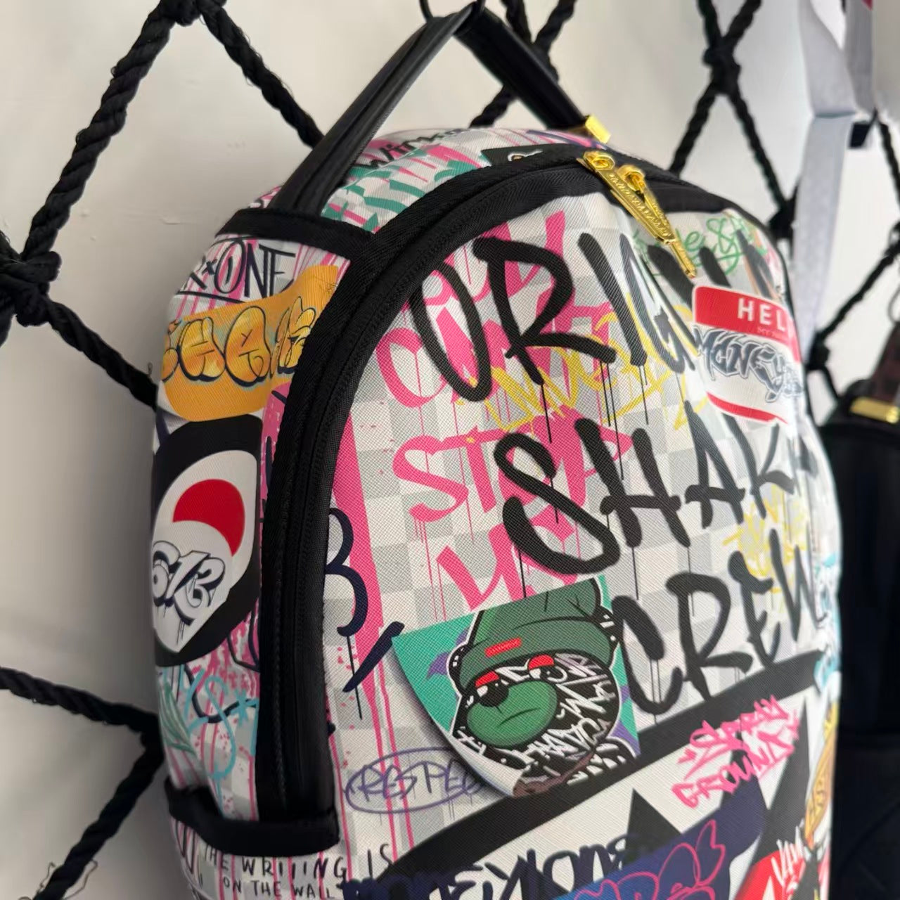 Streetwear Graffiti Collage Backpack - Light Checkerboard Base with Colorful Handwritten Lettering & Sticker Design