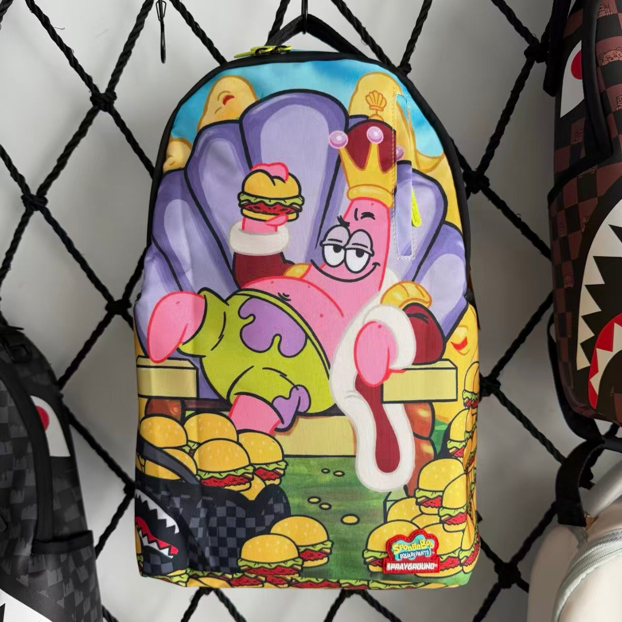 Cartoon Streetwear Backpack - Playful Pink Starfish with Crown Enjoying Hamburger Graffiti Illustration